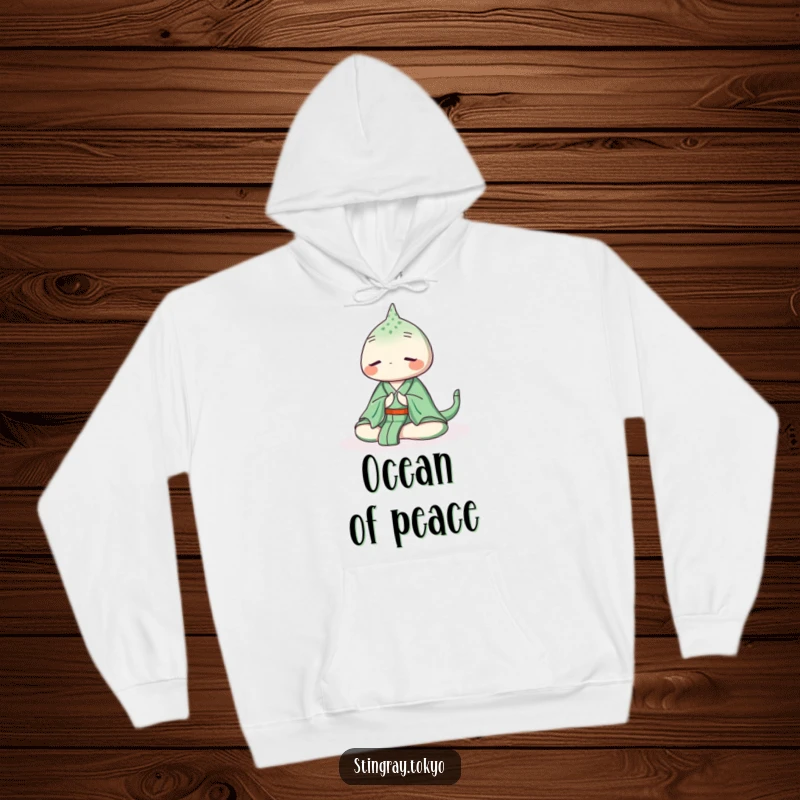 Funny stingray hoodie featuring a serene sea creature in a green kimono meditating peacefully underwater, offering warmth and tranquil charm.
